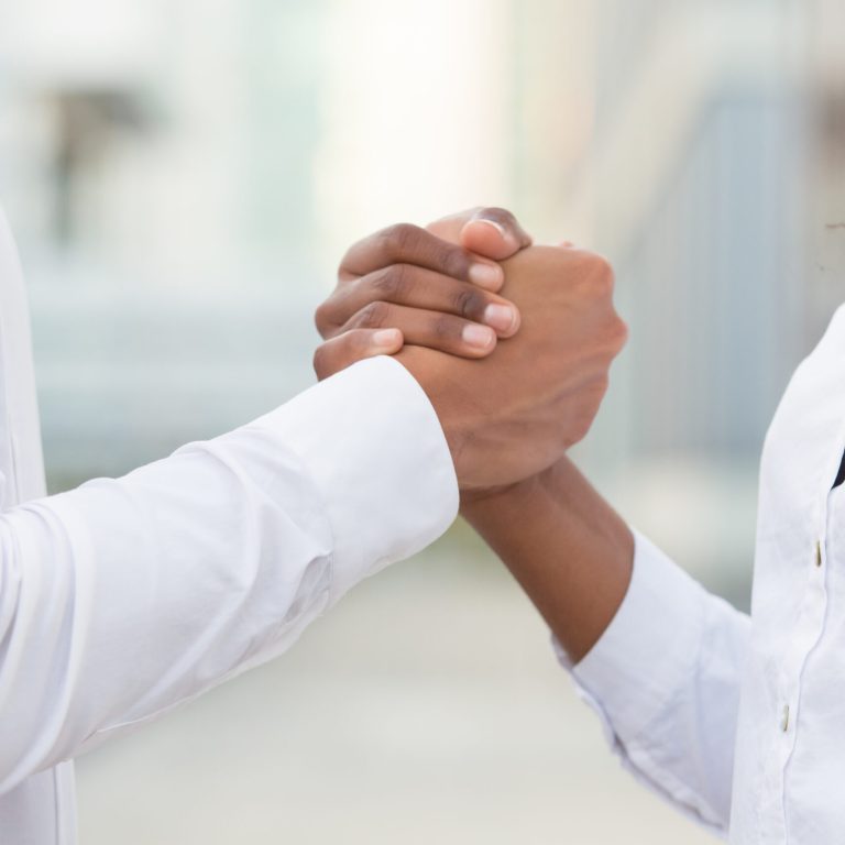 Business colleagues shaking hands for corporate success, support and unity. Closeup of business man and woman handshake. Successful team concept