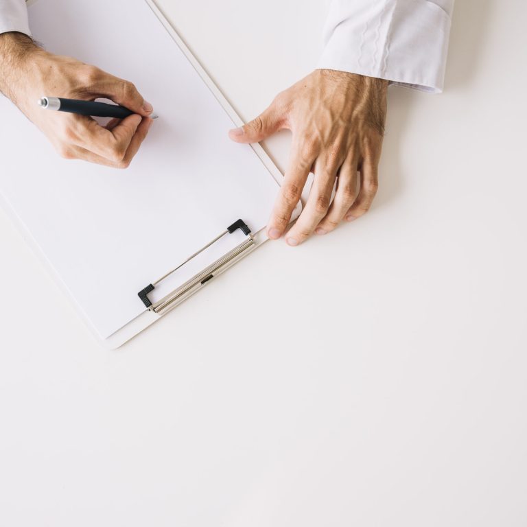 high-angle-view-doctor-hand-writing-blank-white-paper